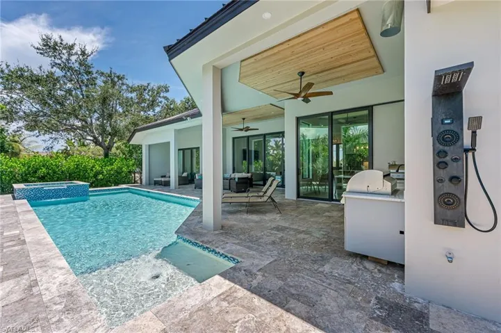 View of swimming pool with a patio, an outdoor living space, a pool with connected hot tub, and area for grilling