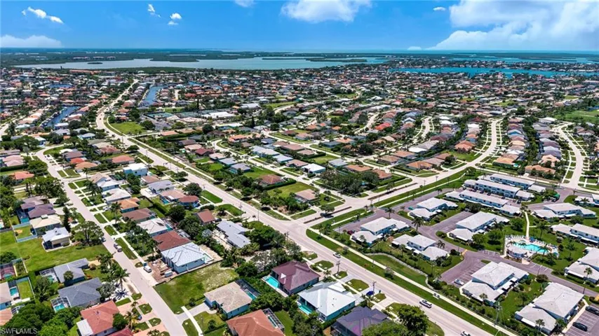 Aerial view of property's location featuring nearby suburban area and a nearby body of water
