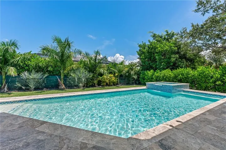 View of swimming pool featuring a pool with connected hot tub