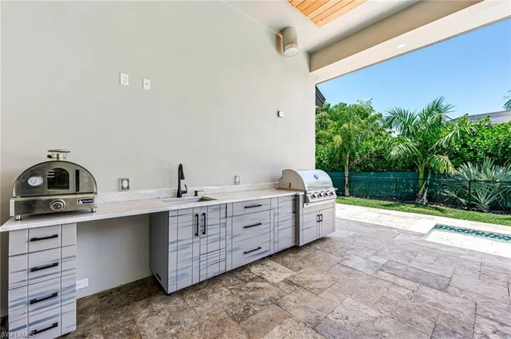 View of patio with a sink and an outdoor kitchen