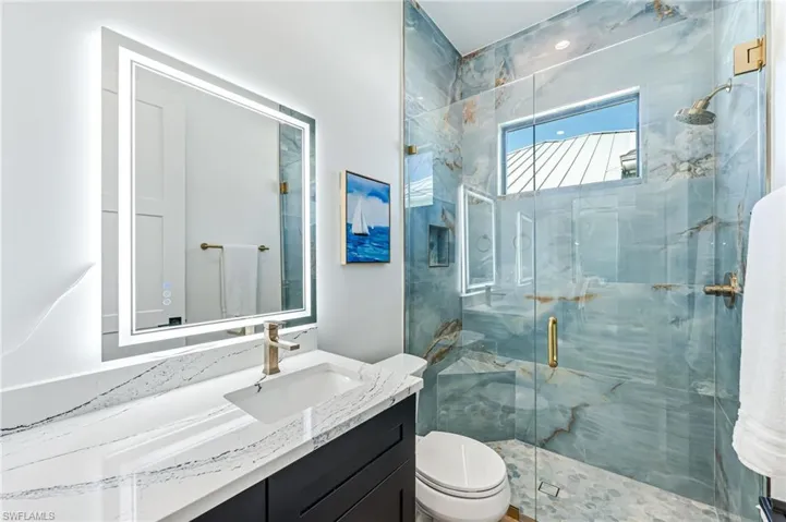 Full bathroom with vanity and a marble finish shower