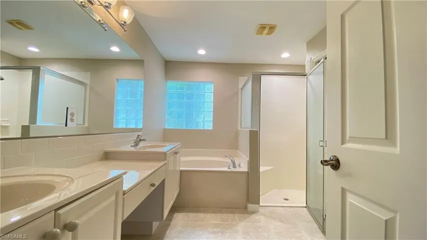 Bathroom with a stall shower, a garden tub, recessed lighting, and light tile patterned floors