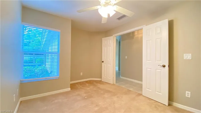 Unfurnished bedroom with carpet and ceiling fan
