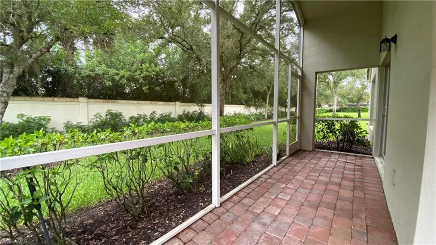 Unfurnished sunroom featuring view of scattered trees