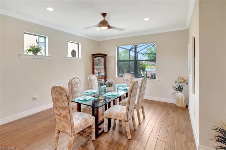 Dining space featuring crown molding, light wood-style flooring, ceiling fan, and recessed lighting