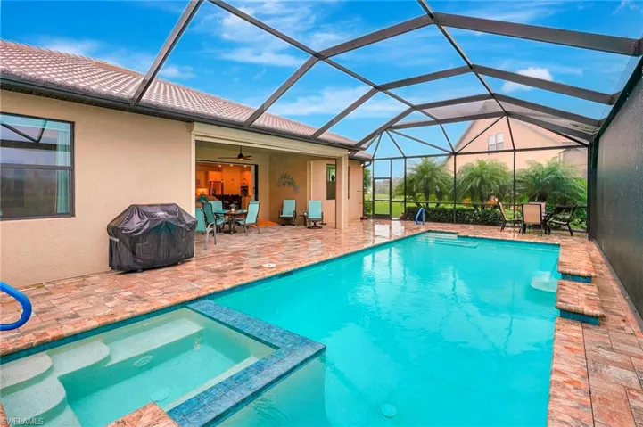 View of pool with a sunroom, a patio, ceiling fan, a grill, and a lanai
