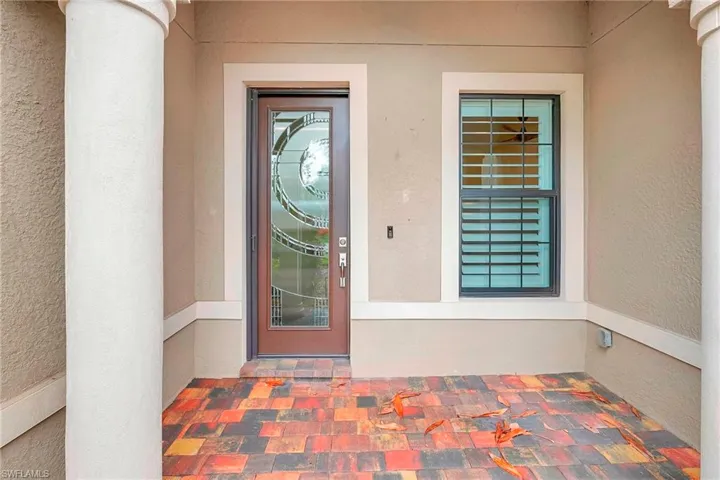 Entrance to property with stucco siding
