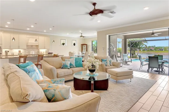 Living area with crown molding, recessed lighting, light wood-style floors, a ceiling fan, and a sunroom