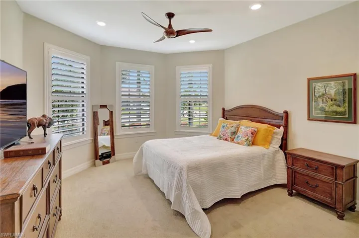 Bedroom with light colored carpet, recessed lighting, and ceiling fan