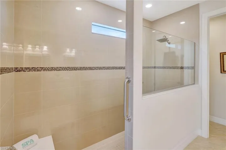 Full bathroom featuring walk in shower, tile patterned flooring, and recessed lighting