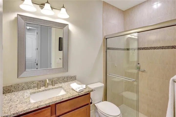 Bathroom featuring vanity and a shower stall