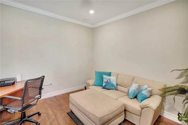 Office space with crown molding, wood finished floors, and recessed lighting