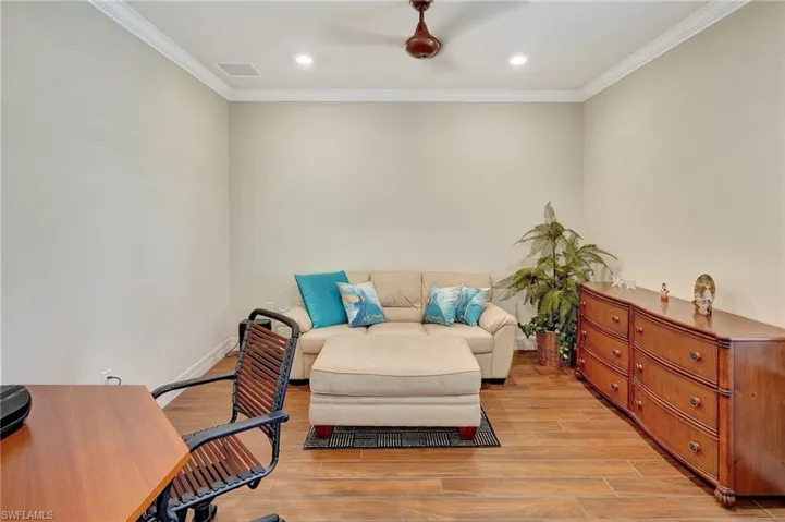 Sitting room featuring ornamental molding, light wood finished floors, an office area, recessed lighting, and a ceiling fan