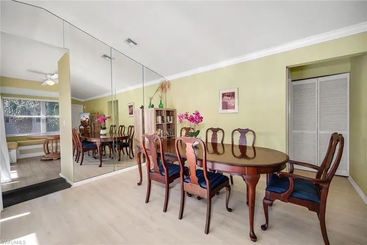 Dining room with crown molding, wood finished floors, and a ceiling fan