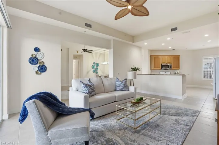 Living area with recessed lighting, ceiling fan, and light tile patterned floors
