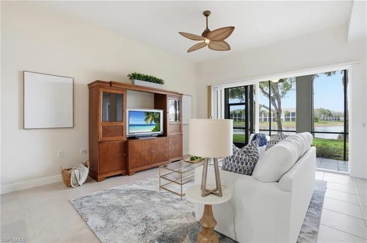 Living room featuring a ceiling fan and baseboards