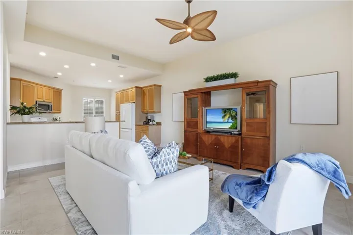 Living room featuring light tile patterned flooring, recessed lighting, and ceiling fan
