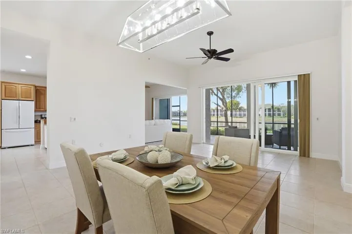 Dining area with light tile patterned floors, recessed lighting, and ceiling fan