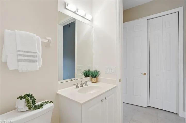 Bathroom 2 featuring vanity, a closet, and light tile patterned floors