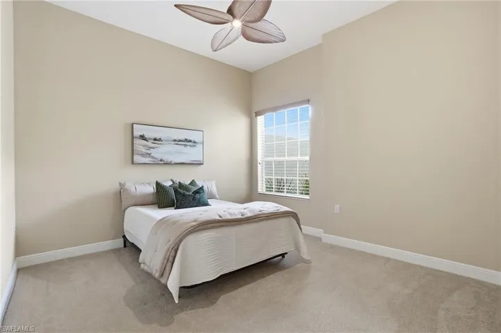 Bedroom featuring light carpet and a ceiling fan