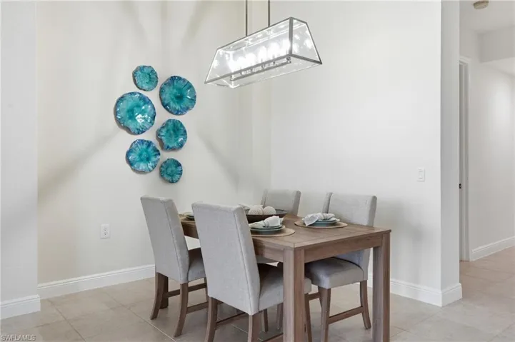 Dining space with light tile patterned floors
