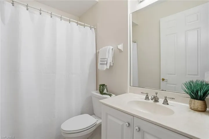 Bathroom 2 with vanity and a shower with curtain