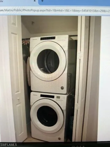 Laundry area featuring stacked washer / dryer