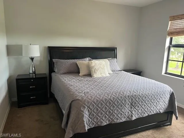 Upstairs Bedroom featuring light carpet & ceiling fan