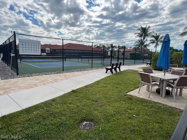 Tennis courts with a patio area