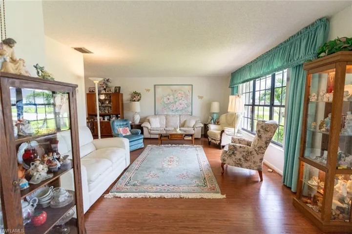 Living area featuring a textured ceiling and wood finished floors