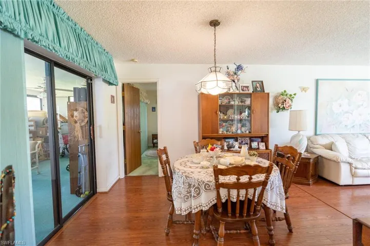 Dining area featuring a textured ceiling and wood finished floors