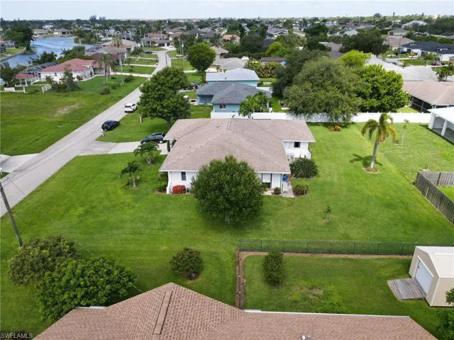 Aerial perspective of suburban area featuring a nearby body of water