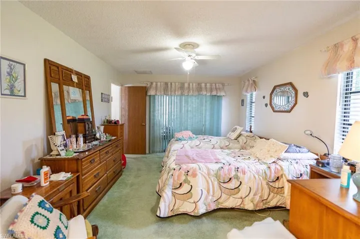 Master Bedroom with carpet flooring, ceiling fan, and a textured ceiling