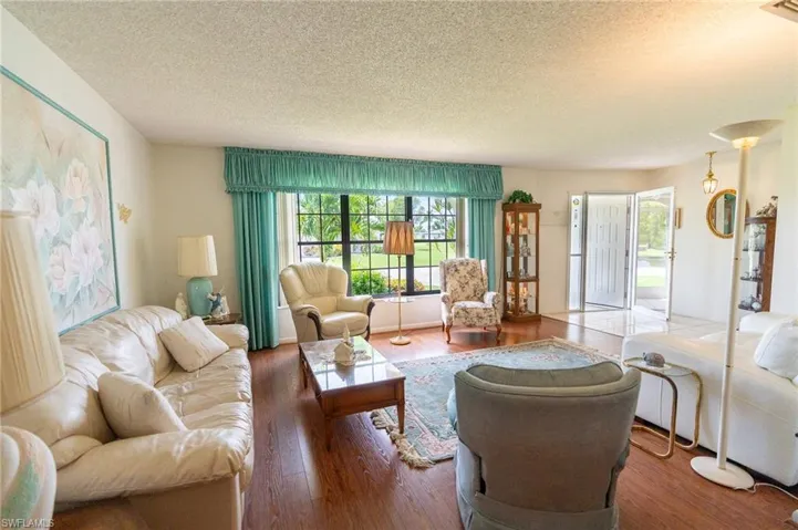 Living area featuring a textured ceiling and wood finished floors