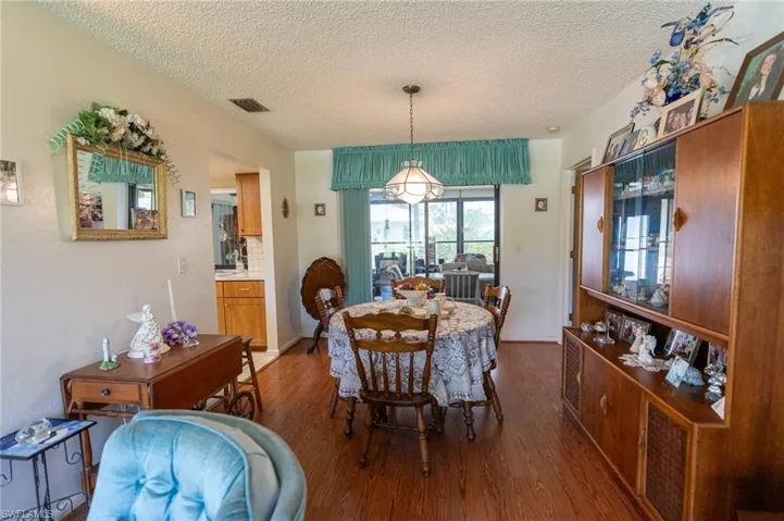 Dining room with wood finished floors and a textured ceiling