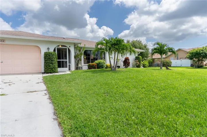 View of front of home featuring stucco siding, concrete driveway, and an attached garage