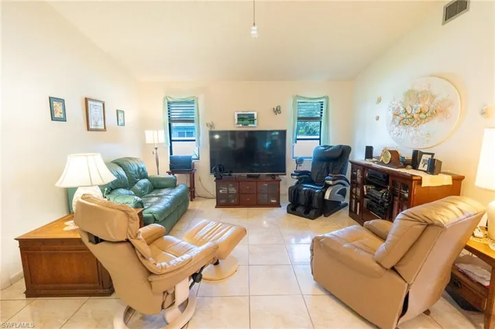 Living area featuring healthy amount of natural light and light tile patterned floors