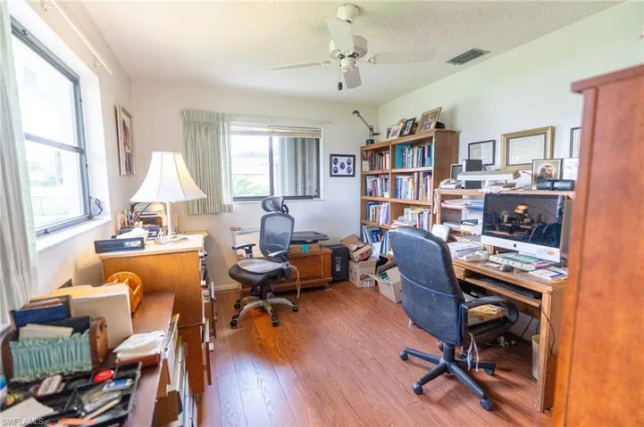 Bedroom being used as a Home office featuring wood finished floors and a ceiling fan