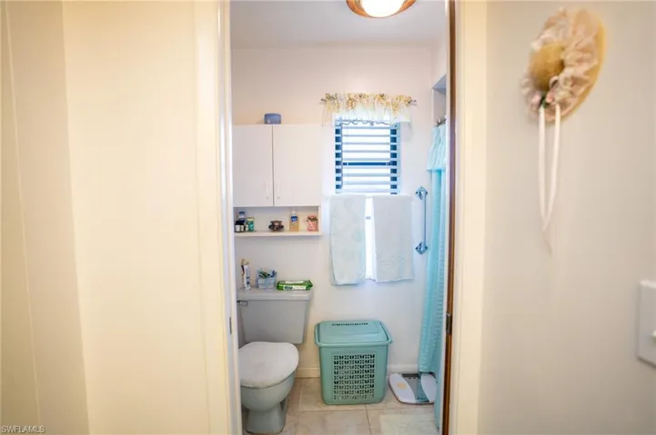Master Bathroom featuring tile patterned flooring and a shower with shower curtain