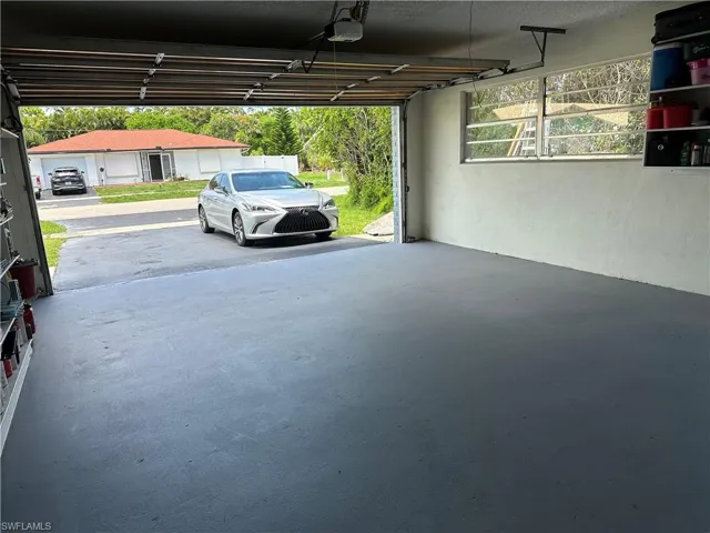 Garage featuring a carport and a garage door opener