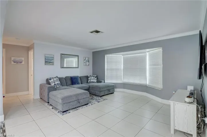 Tiled living room with ornamental molding