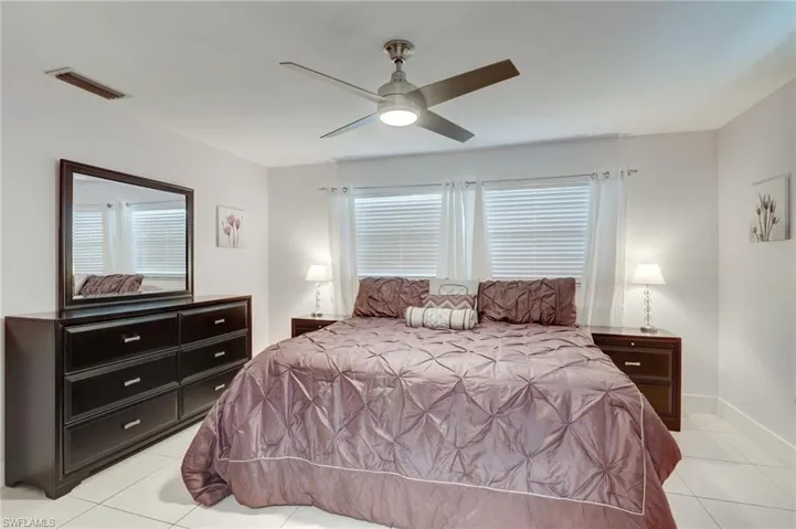 Tiled bedroom with ceiling fan