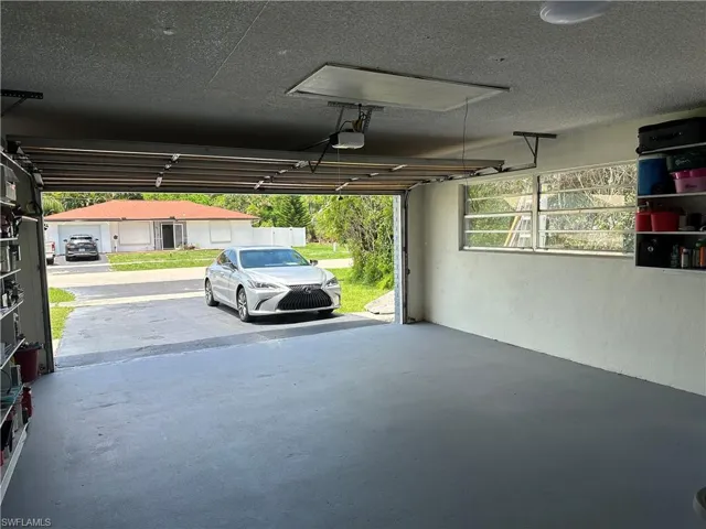 Garage featuring a carport and a garage door opener