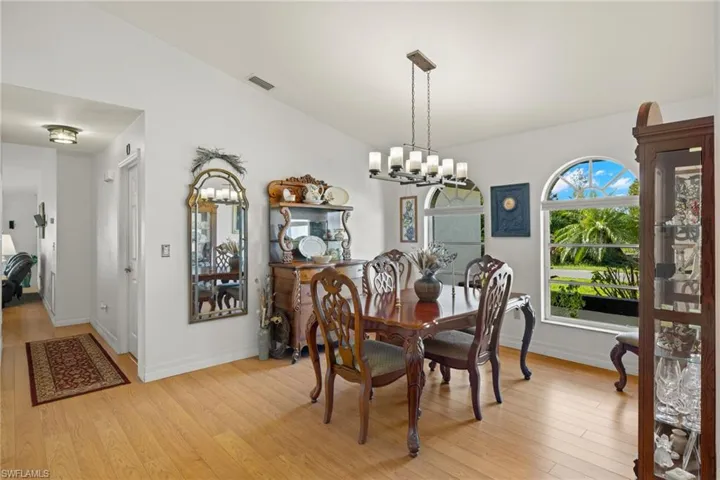 Dining area featuring an inviting chandelier and light wood-type flooring