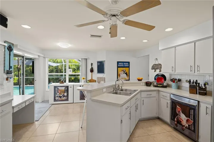 Kitchen featuring sink, kitchen peninsula, dishwasher and ceiling fan