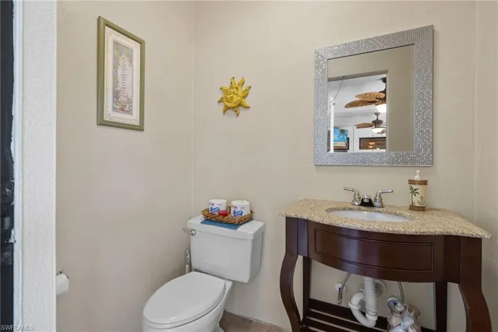 Bathroom featuring vanity, and toilet