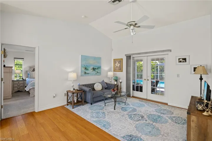 Living room with french doors, high vaulted ceiling, and ceiling fan