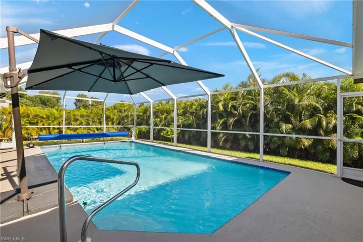 View of swimming pool with a patio area and screen enclosure