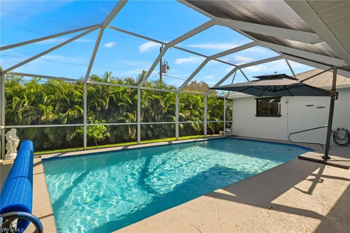 View of swimming pool featuring a patio and a lanai