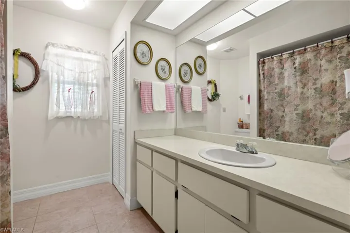 Bathroom with tile patterned floors and vanity